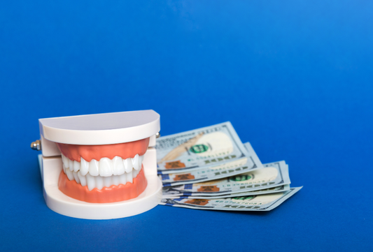 Teeth model with euro money illustrating clear aligner cost in Europe and affordable smile correction options.