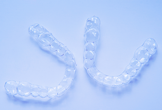 Clear aligners trays showing teeth alignment treatment – retainers vs clear aligners concept.