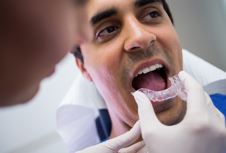 Patient being fitted with transparent aligners at dental clinic